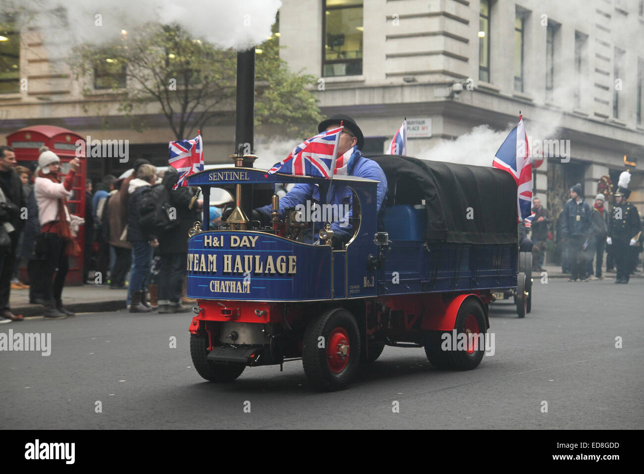 London, UK. 1 January 2015. An operator attends to his mini steam engine. Londoners and tourists turned up in droves for the new years parade. The annual parade goes through Piccadilly, Regents street, Pall Mall and Whitehall a 2 mile route. Photo: David Mbiyu/ Alamy Live News Stock Photo