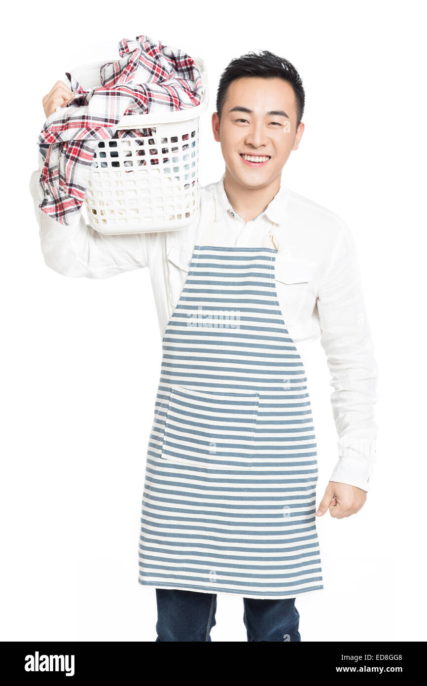 cheerful man holding a laundry basket isolated on white background Stock Photo