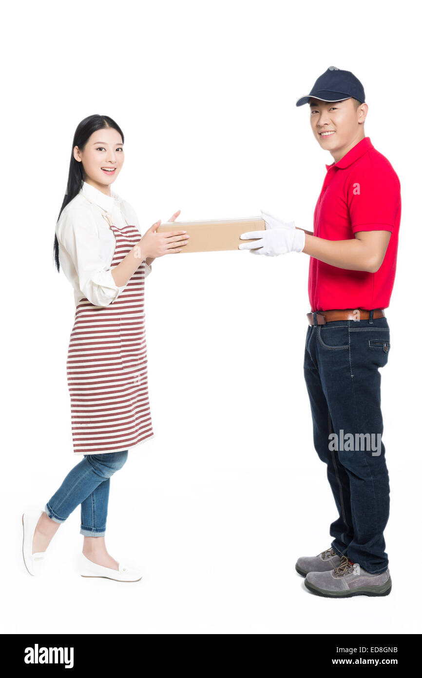 young courier deliver package to pretty woman, white background. Stock Photo