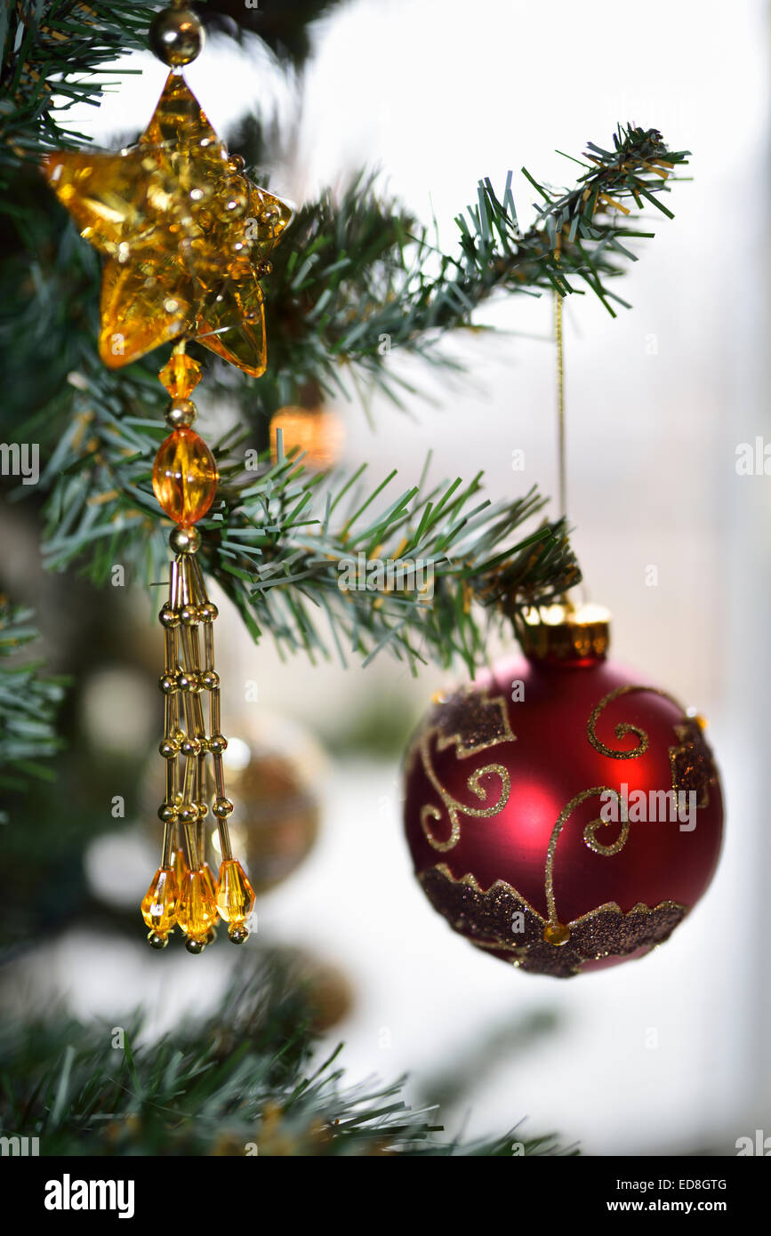 Red and gold ornaments hanging from a Christmas tree Stock Photo - Alamy