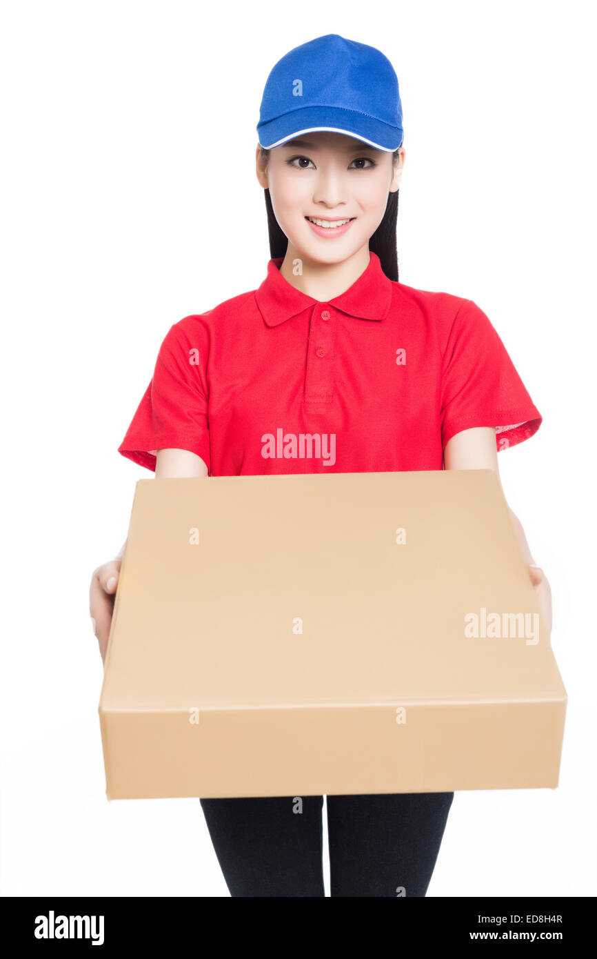 delivery woman carrying cardboard box, white background. Stock Photo
