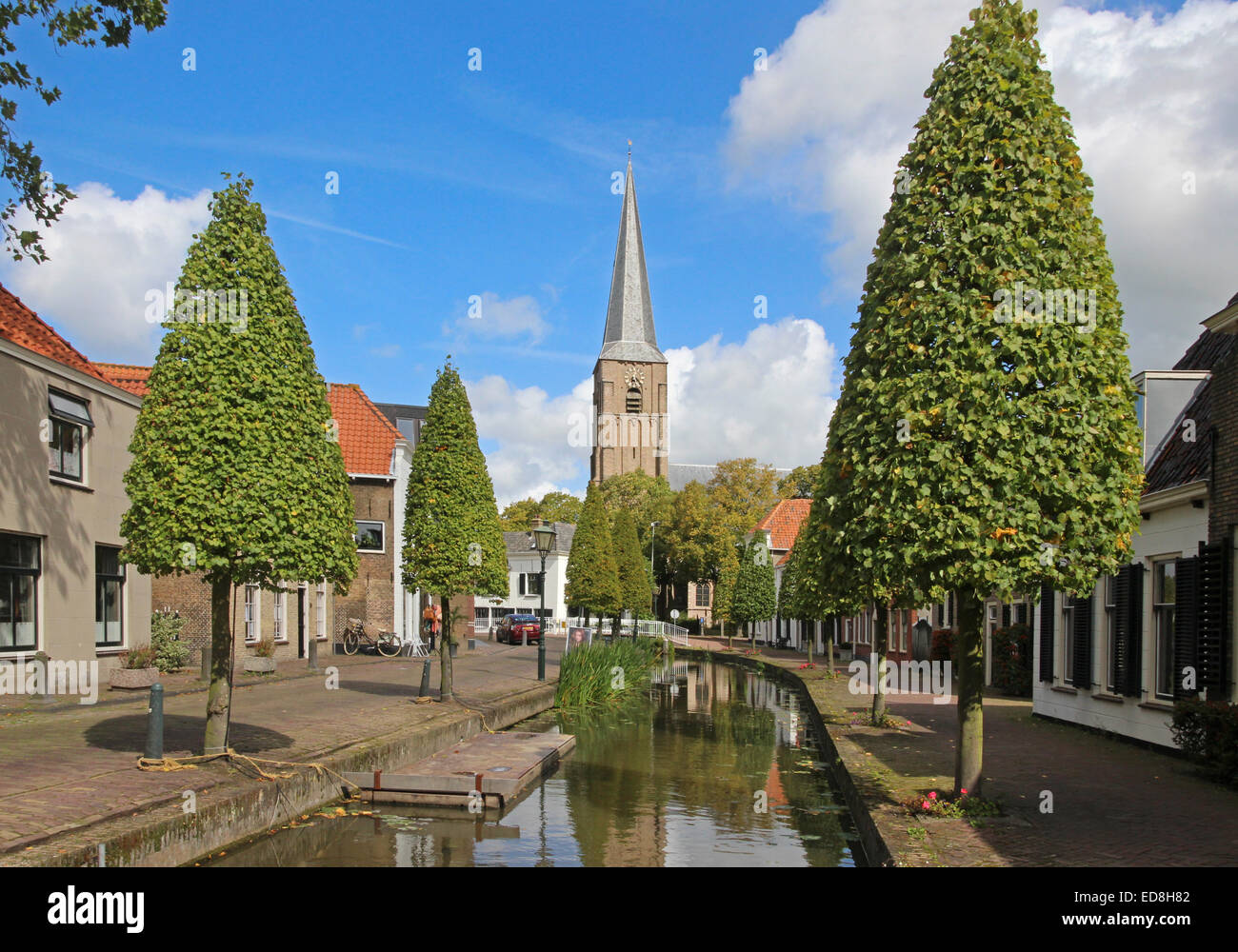 View along a canal in Maasland towards the Oude Kerk. Stock Photo