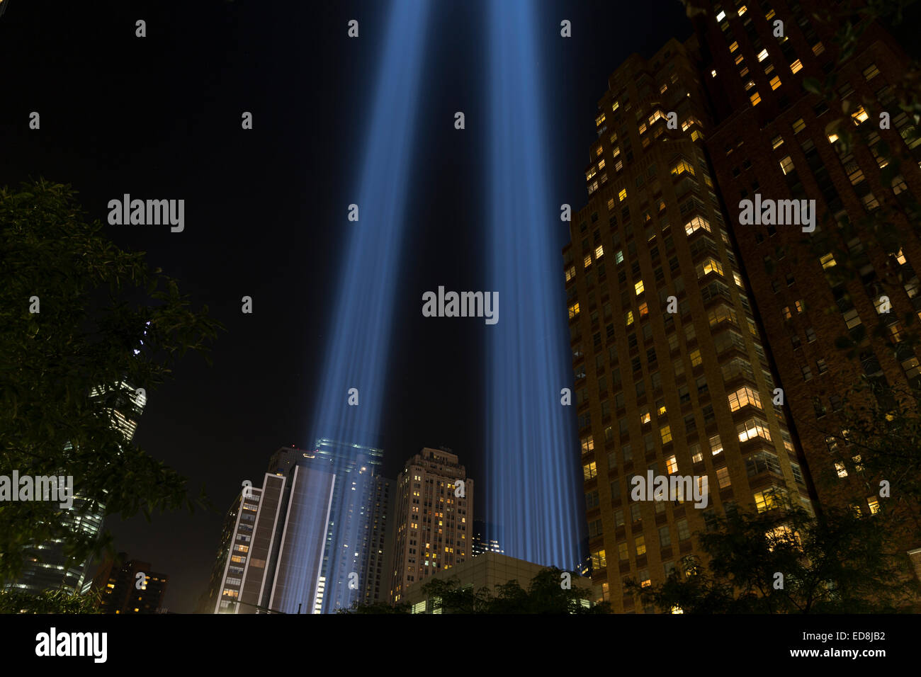NEW YORK, NY USA - SEPTEMBER 11, 2014: Light tribute to World Trade Center 911 tragedy in downtown Manhattan with Freedom Tower on background Stock Photo