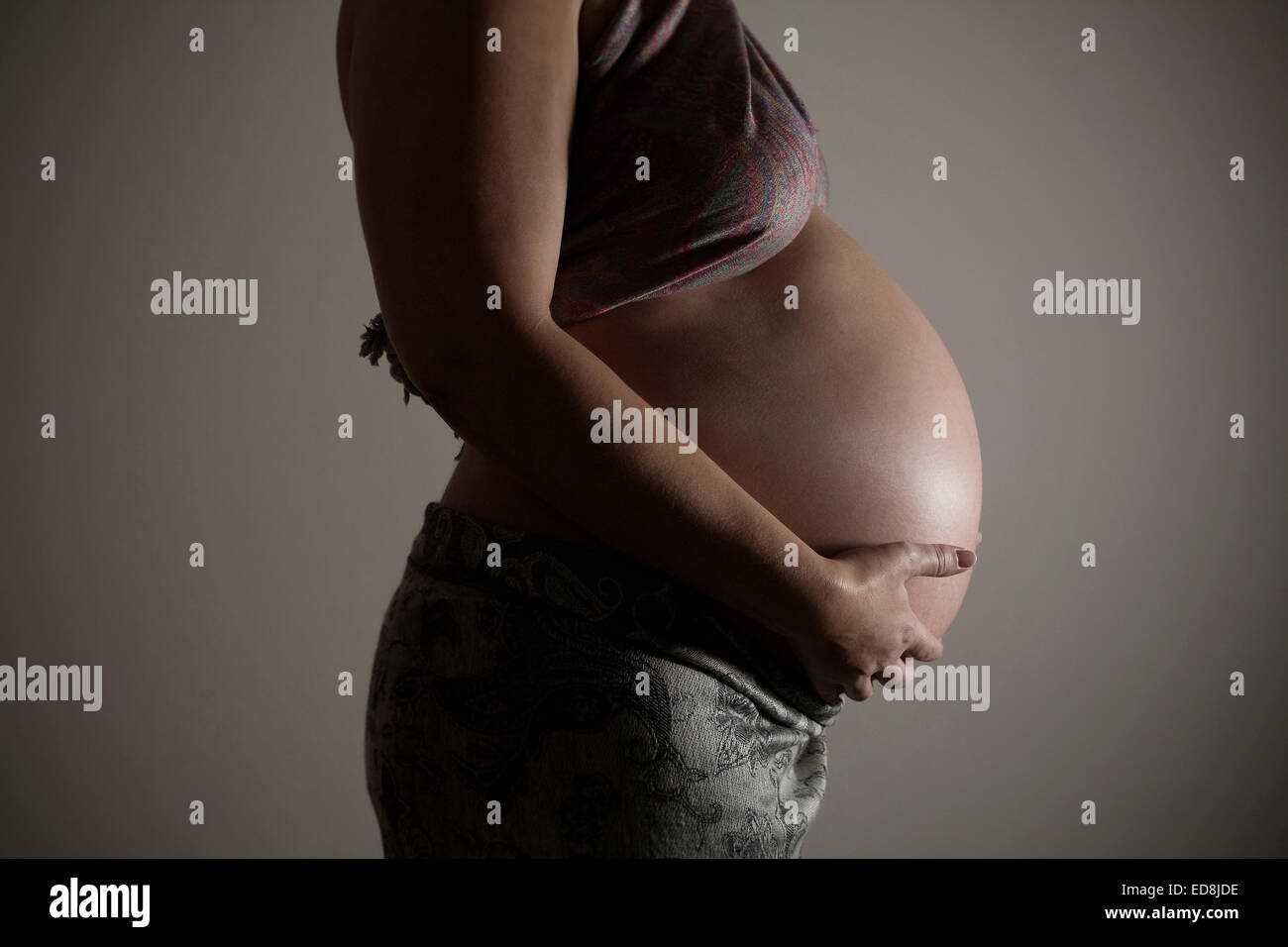 A side shot of a pregnant woman at 37 weeks gestation. Stock Photo