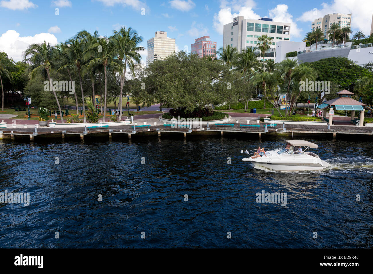 Ft. Lauderdale, Florida.  Pleasure Boat on New River Passing H. Wayne Huizenga Plaza, formerly Bubier Park. Stock Photo