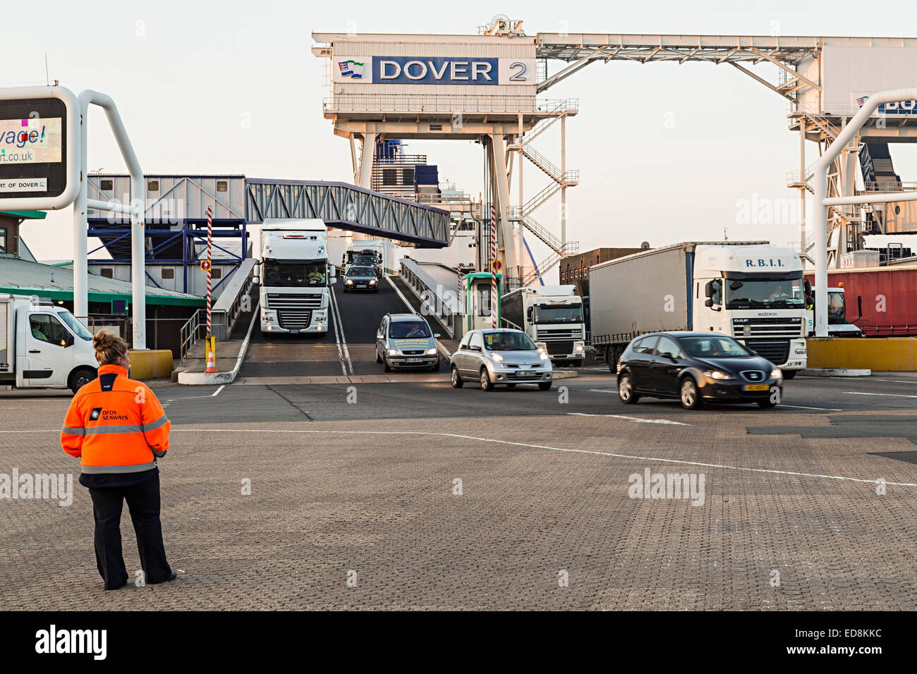 DFDS Ferry security person watching cars and lorries disembark at Port of Dover, UK Stock Photo
