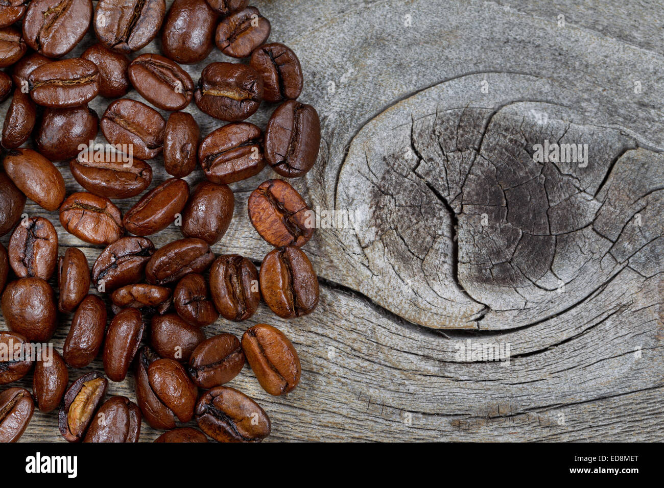 Close up of freshly roasted coffee whole beans on rustic naturally aged wood Stock Photo