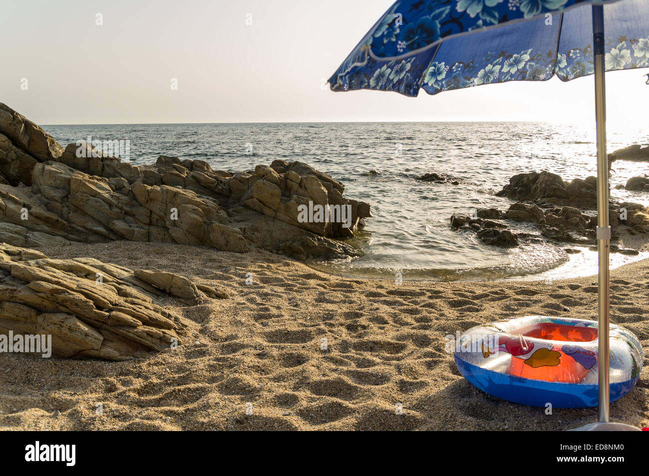 sunset at the beach under an umbrella Stock Photo