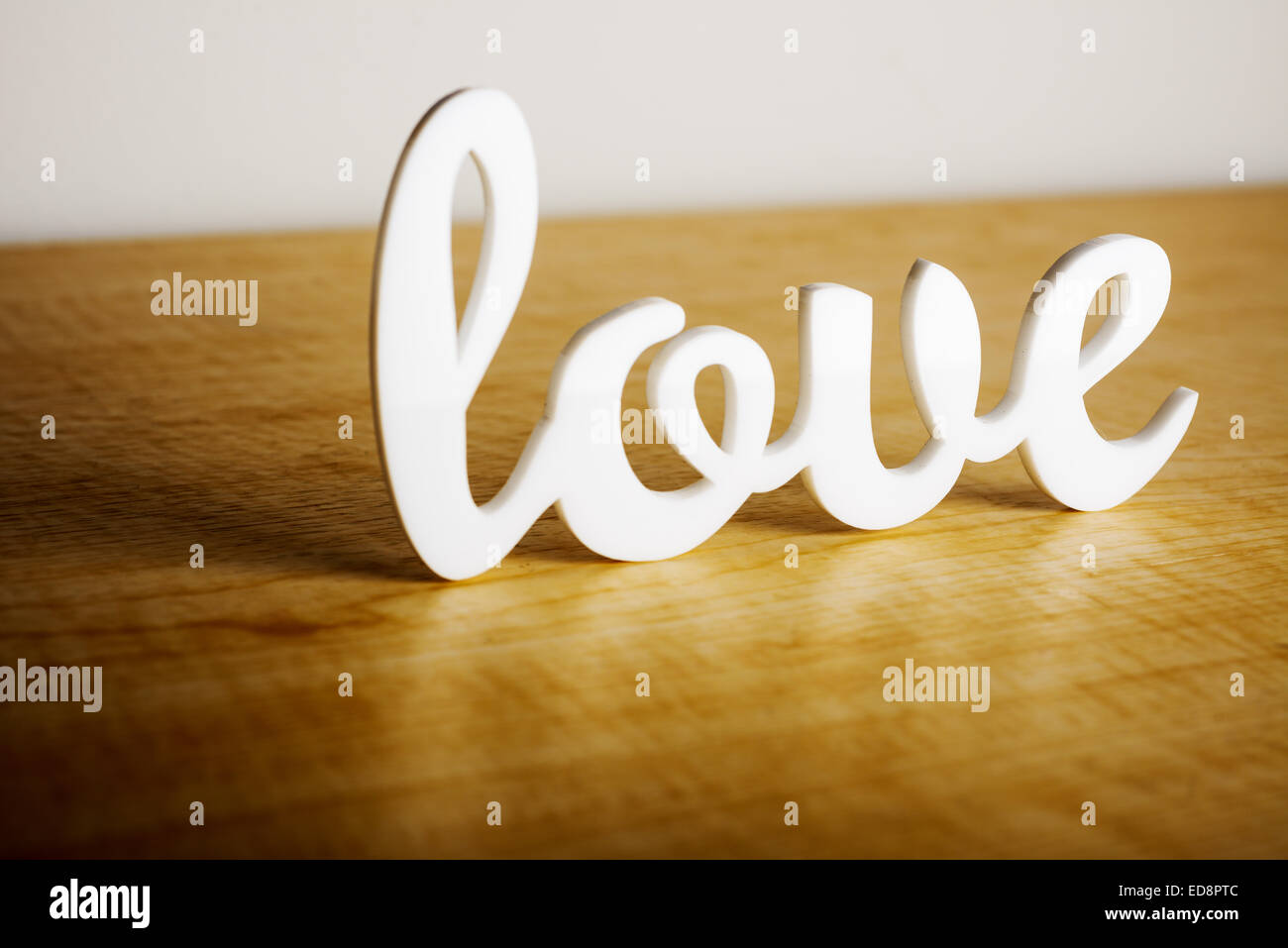 Love sign on wooden table. Stock Photo