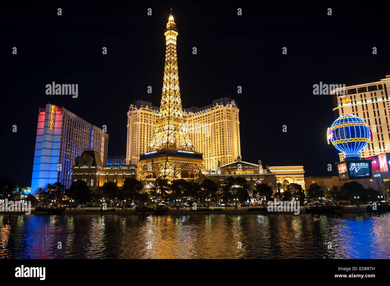 Las Vegas Boulevard by night with Paris Las Vegas and Bally's hotels and casinos as seen over the lake at Bellagio. Stock Photo