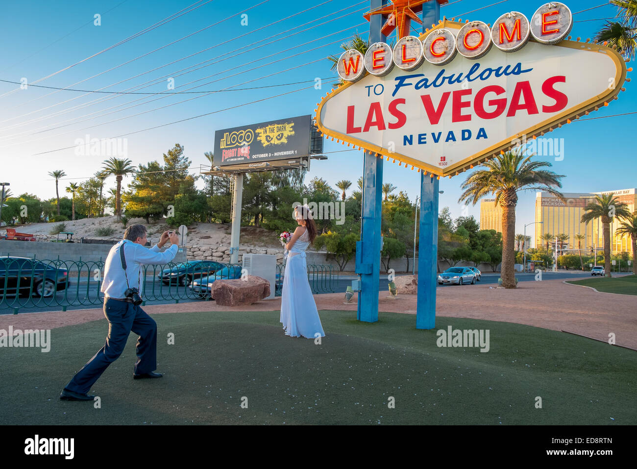 A bride is photographed at the 'Welcome to Fabulous Las Vegas sign' on the southern part of Las Vegas Boulevard. Stock Photo