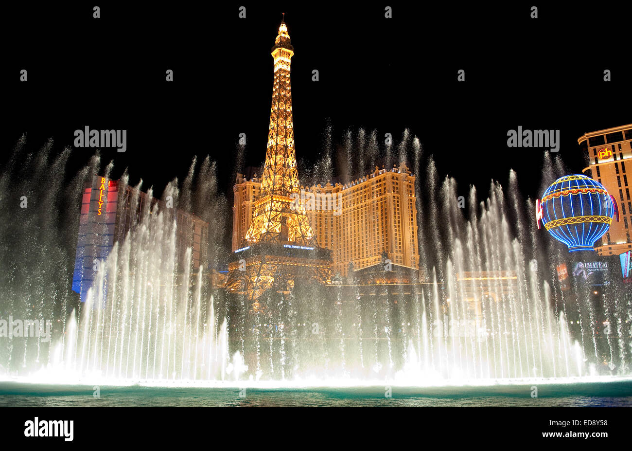 Las Vegas Boulevard by night with Paris Las Vegas and Bally's hotels and casinos as seen over the lake at Bellagio. Stock Photo