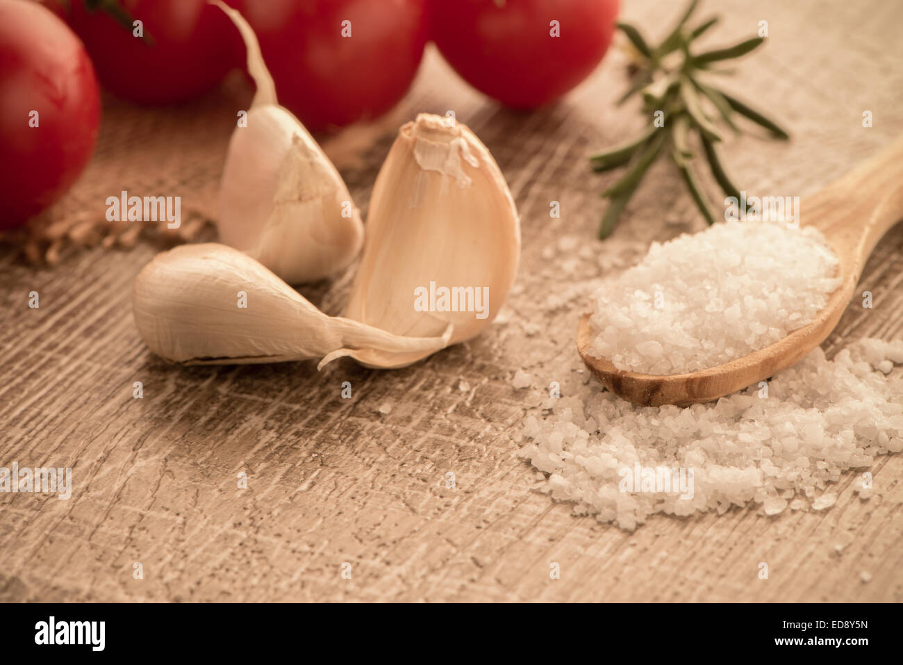 Cherry tomatoes and onion on wooden table Stock Photo - Alamy