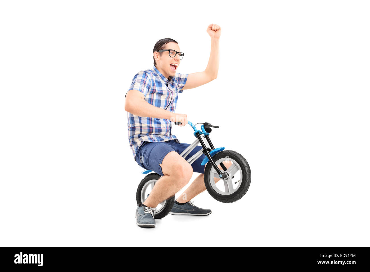 Crazy young man riding a small bike isolated on white background Stock Photo
