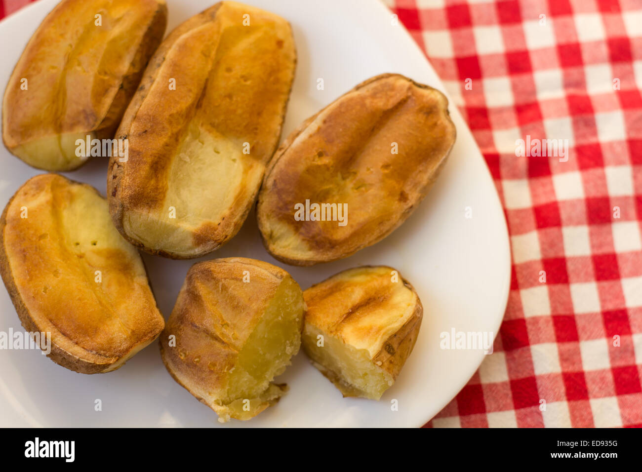 Baked Potato cut in half on the plate Stock Photo - Alamy