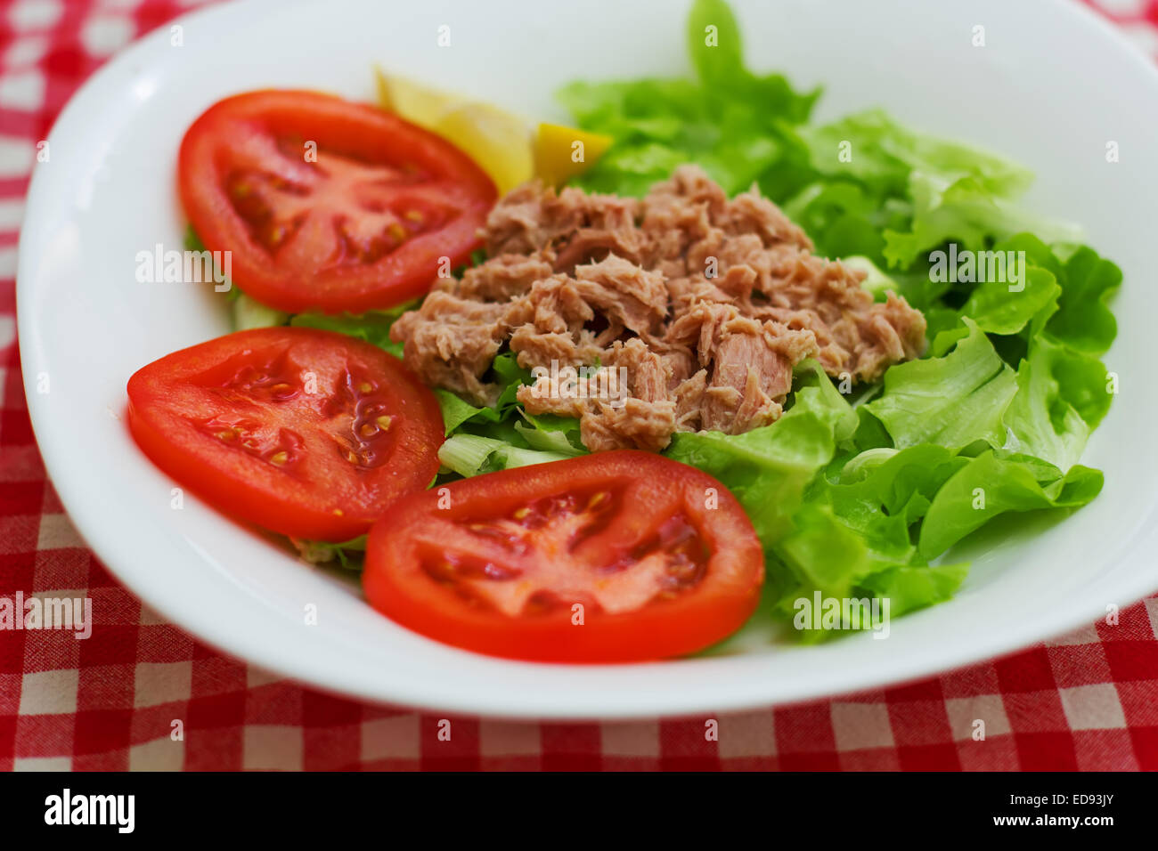 Tuna Fish Meat Over Green Salad with red tomato on plate Stock Photo ...