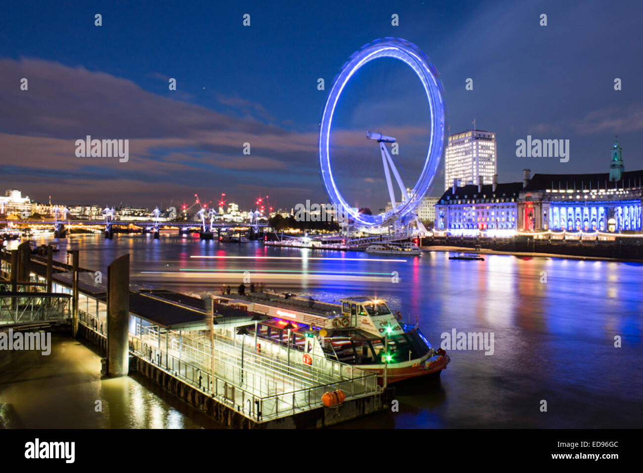 The London Eye and County Hall Hotel illuminated at twilight on the ...
