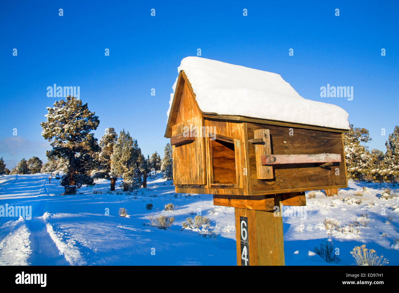 A rural wooden mail box and newspaper box along a country road in central Oregon Stock Photo
