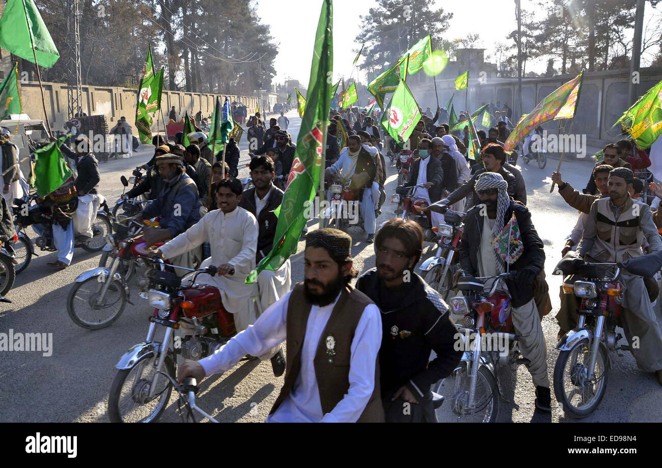 Members of Jamat-e-Ahle Sunnat holding a rally to show their devotion and love with Holy Prophet Muhammad (PBUH) in connection of 12th Rabiulawal, the birthday anniversary of Holy Prophet (PBUH) passing through Zarghoon Road of Quetta on Friday, January 02, 2015. Stock Photo