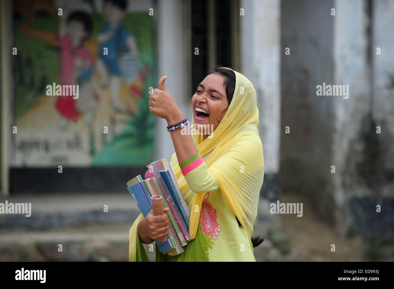 https://c8.alamy.com/comp/ED993J/a-bangladeshi-girl-shows-good-mark-with-her-finger-in-front-of-school-ED993J.jpg