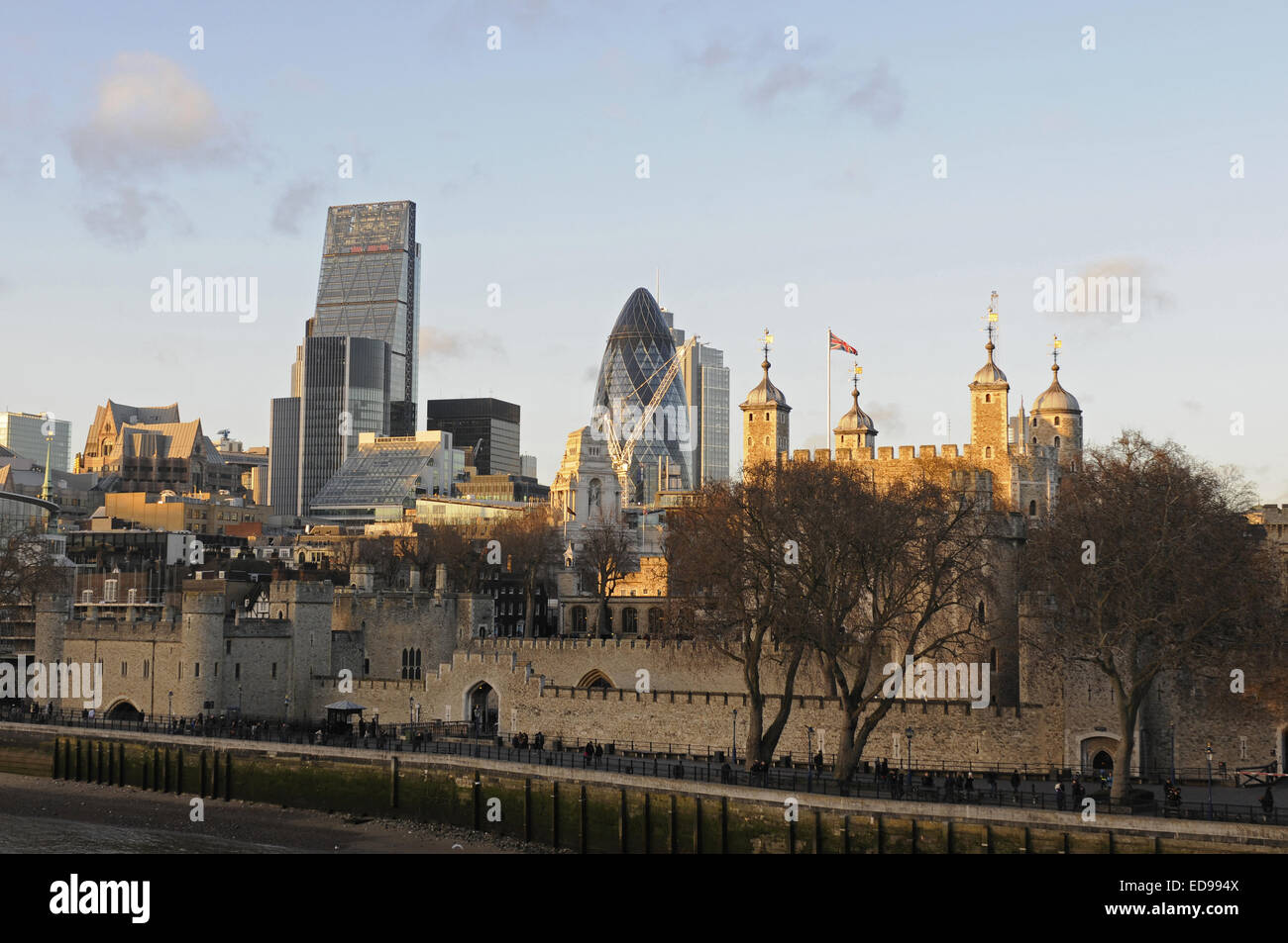 The Modern skyline of the City of London with The Gherkin, The Cheesegrater and Tower of London at sundown and the River Thames Stock Photo
