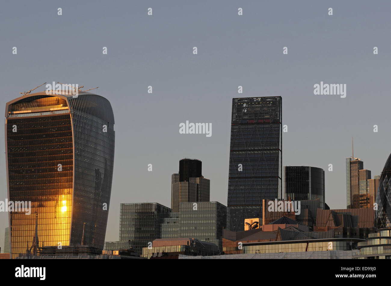 The Modern skyline of the City of London with The Walkie Talkie Building, The Cheesegrater at sundown London England Stock Photo