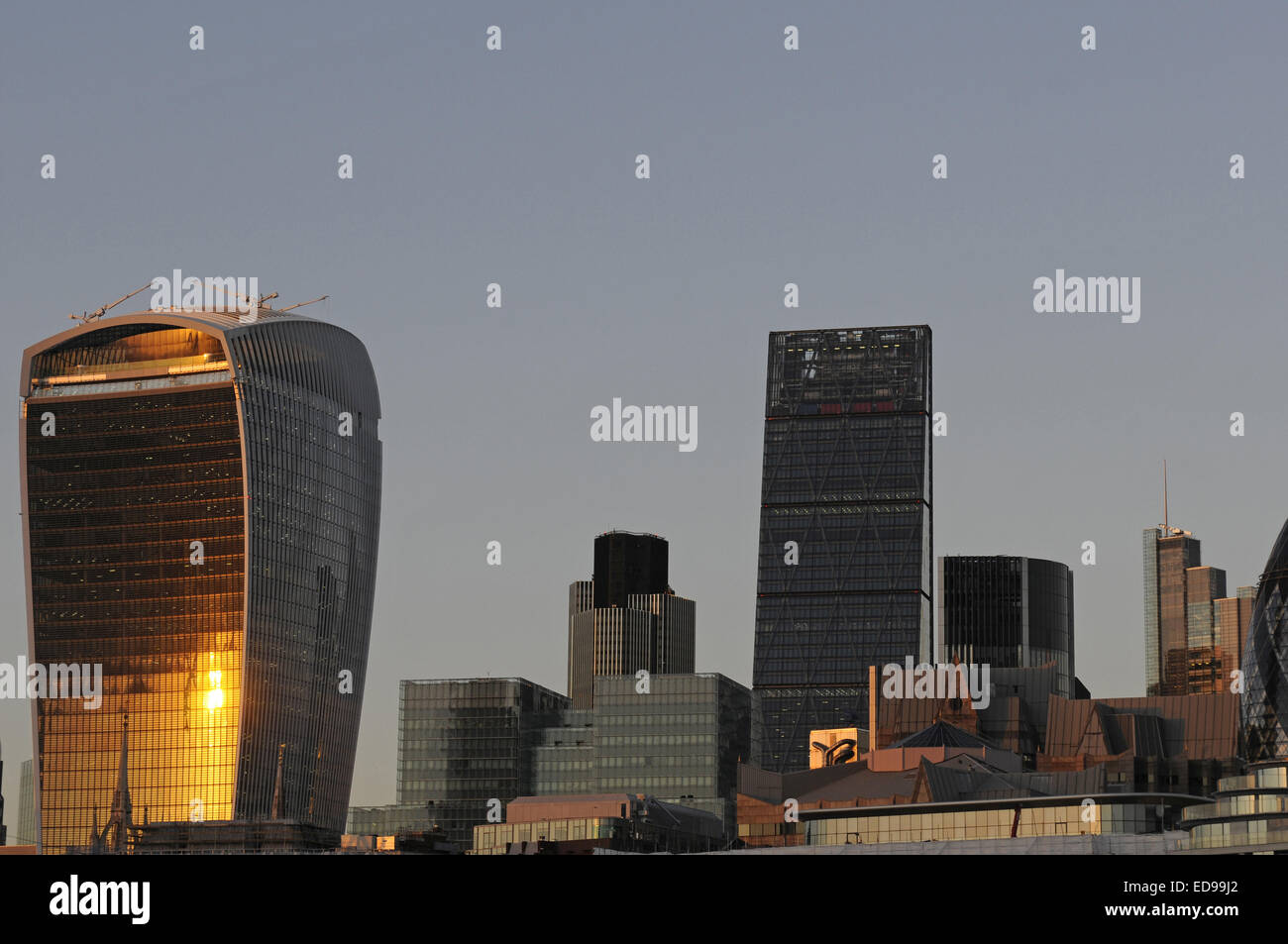 The Modern skyline of the City of London with The Walkie Talkie Building, The Cheesegrater at sundown London England Stock Photo