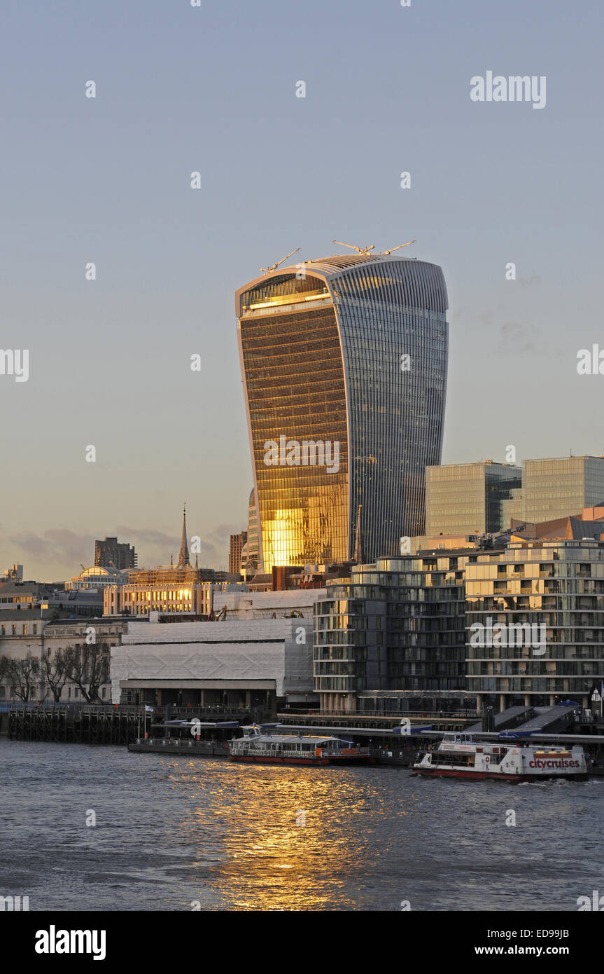 The Modern skyline of the City of London with The Walkie Talkie Building with sunlight reflected in the River Thames London Stock Photo