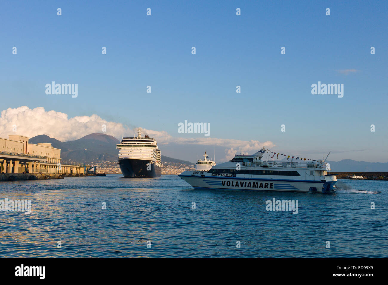 Passenger ferry and cruise ship 'MS Noordam' departing the port at Naples with Vesuvius behind. Naples, Campania, Italy Stock Photo