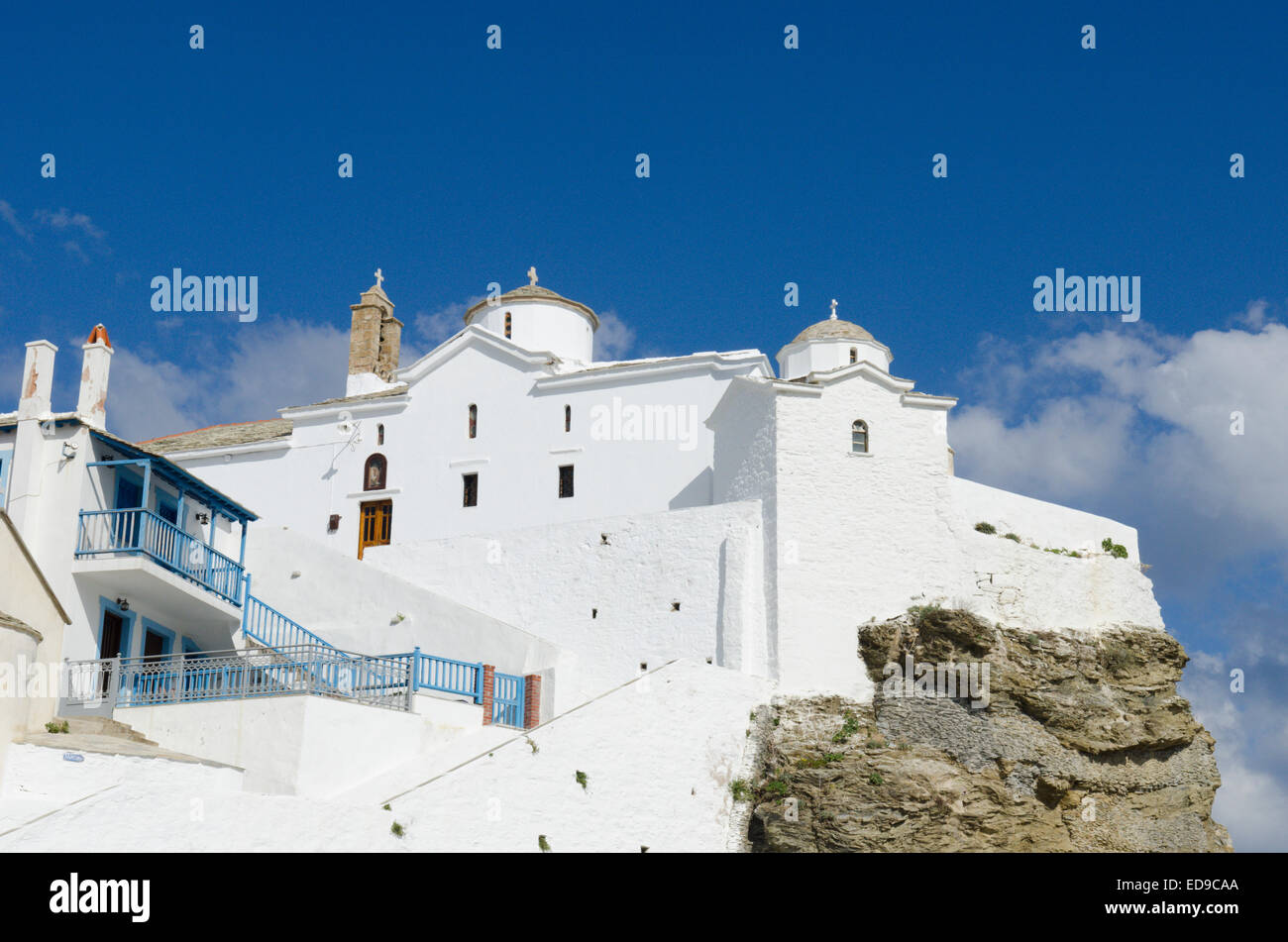 churches of chapels atop the cliff at the edge of the harbour wall. Skopelos Town, Skopelos, Greek island. Stock Photo
