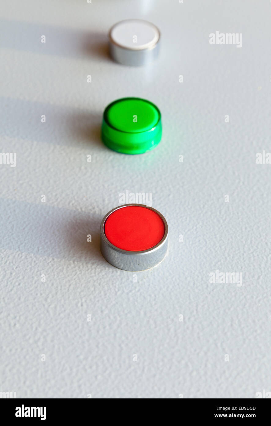 Three industrial buttons in a row on gray steel control panel Stock Photo