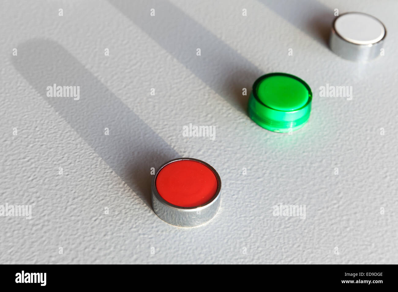 Three industrial buttons on gray steel control panel Stock Photo