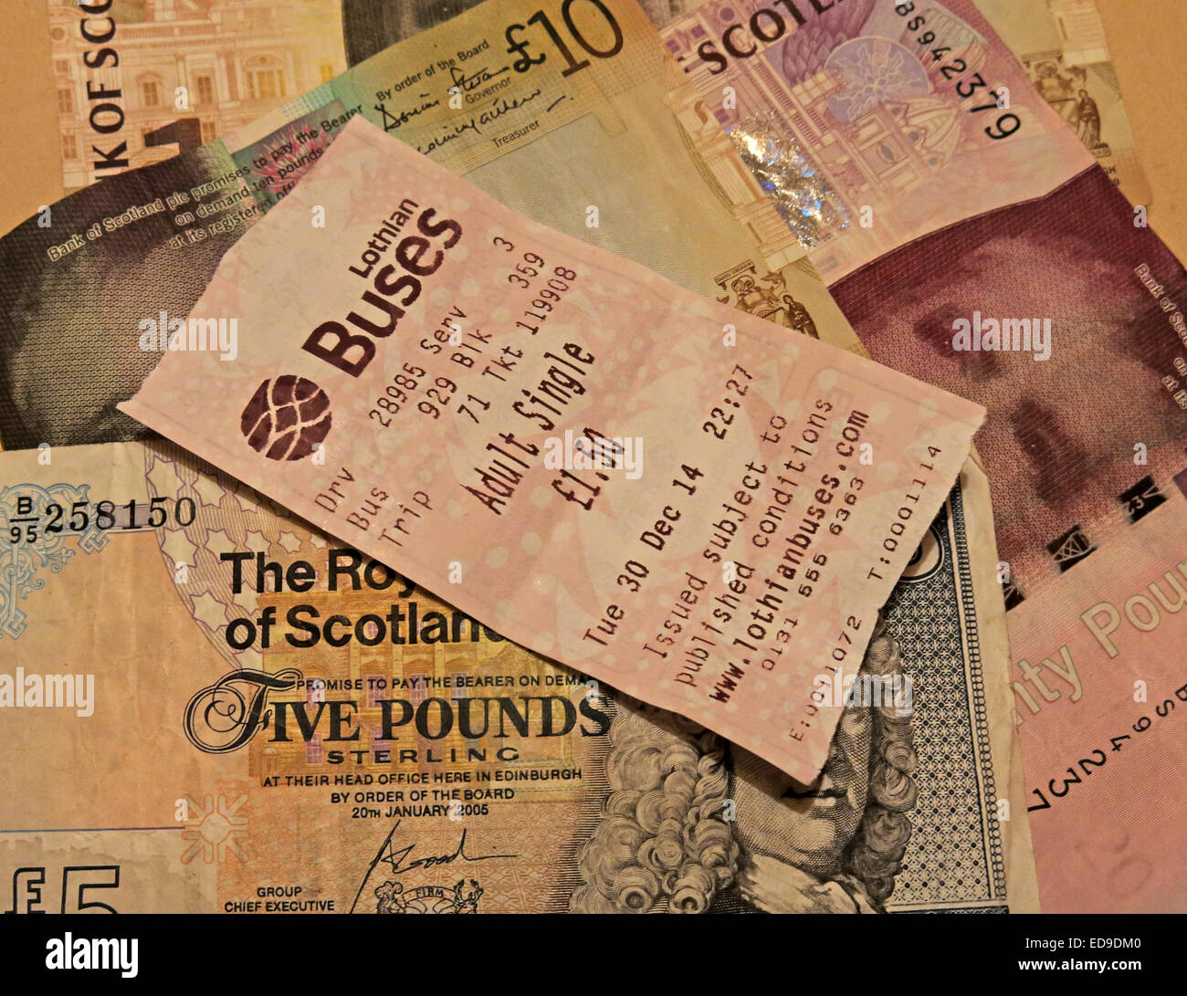 Lothian Buses bus Ticket and Scots banknotes from Edinburgh, Scotland, UK sideways Stock Photo