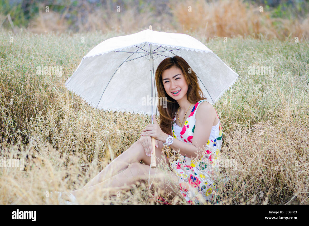 Charming woman on meadow, model is a asian girl. Stock Photo