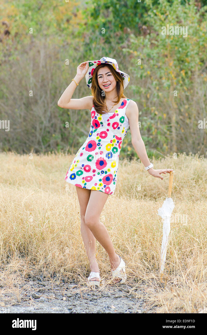 Portrait of charming woman on meadow, model is a asian girl. Stock Photo