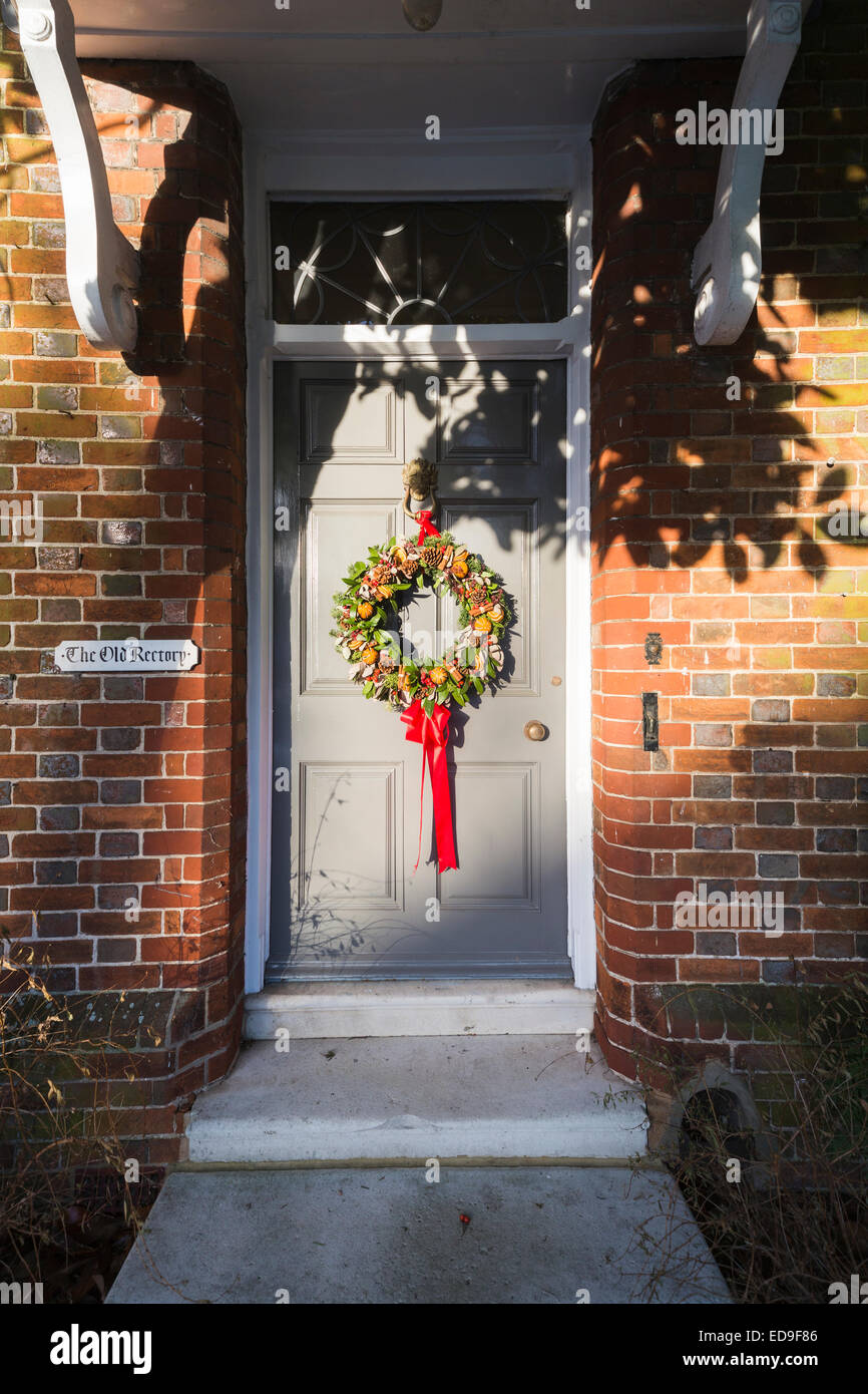 Seasonal festive Christmas wreath on the front door of The Old Rectory in Stockbridge, a village or small town in Test Valley, west Hampshire, UK Stock Photo