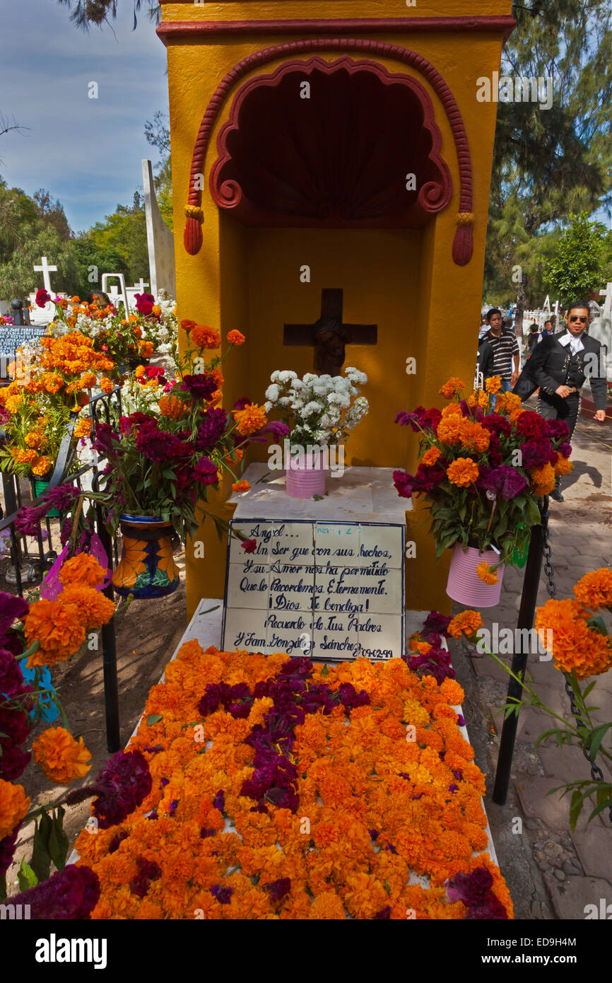 GRAVES are covered with FRESH FLOWERS to loved ones back to earth during DAY OF THE DEAD