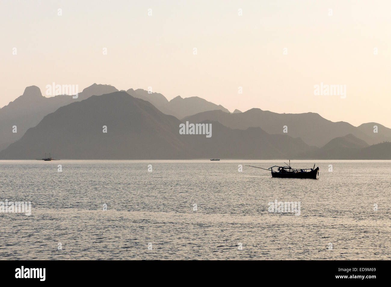 Late afternoon view of fishing boats off the west coast of Komodo island, East Nusa Tenggara, Indonesia. Stock Photo