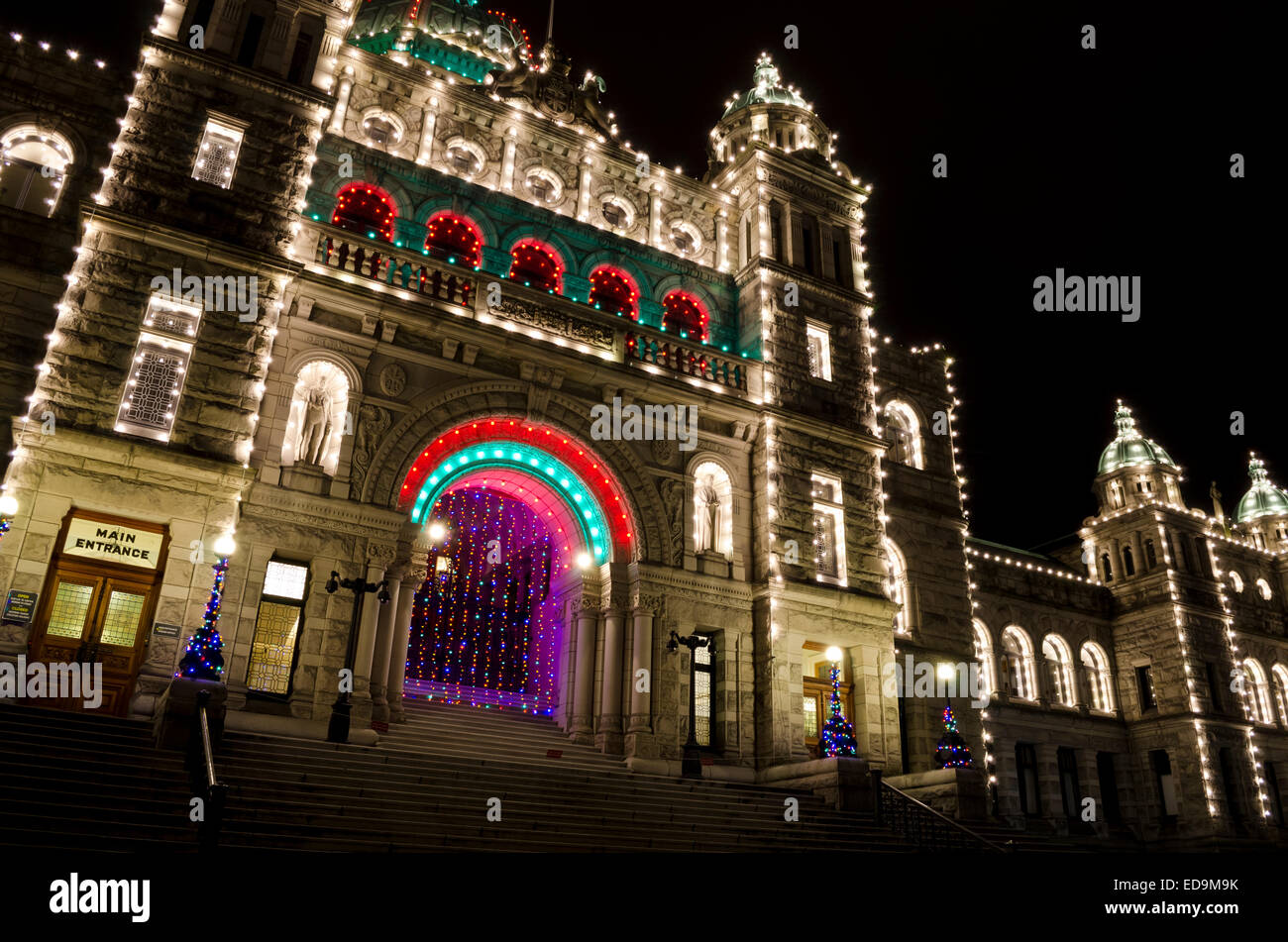 Detailed stonework and statues on the provincial parliament buildings in Victoria, BC, Canada.  Government building lit up. Stock Photo
