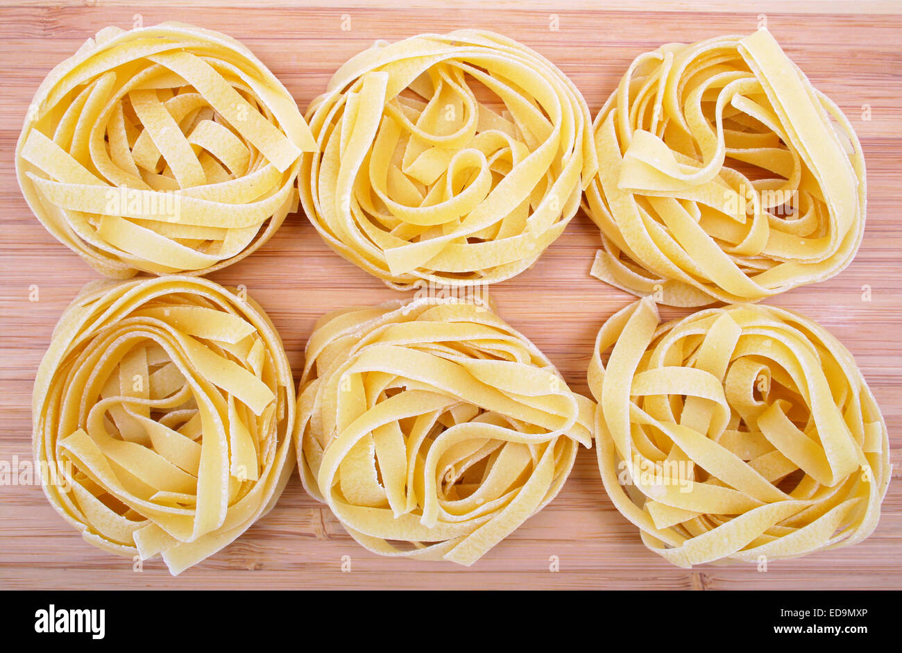 Tagliatelle pasta on the wooden background Stock Photo