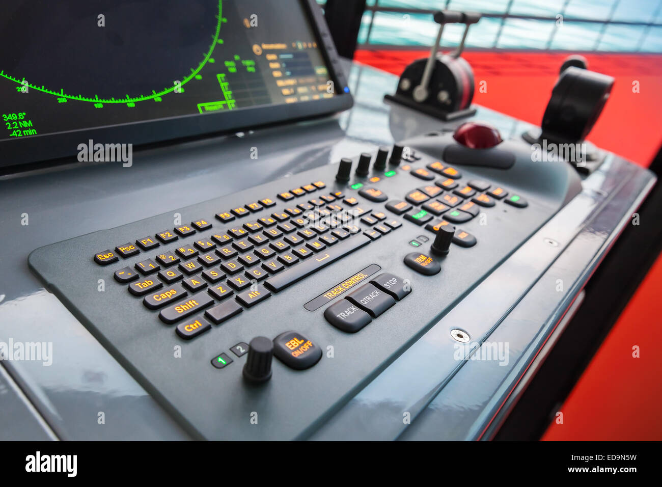 Modern ship control panel with radar screen, accelerator, trackball and keyboard Stock Photo