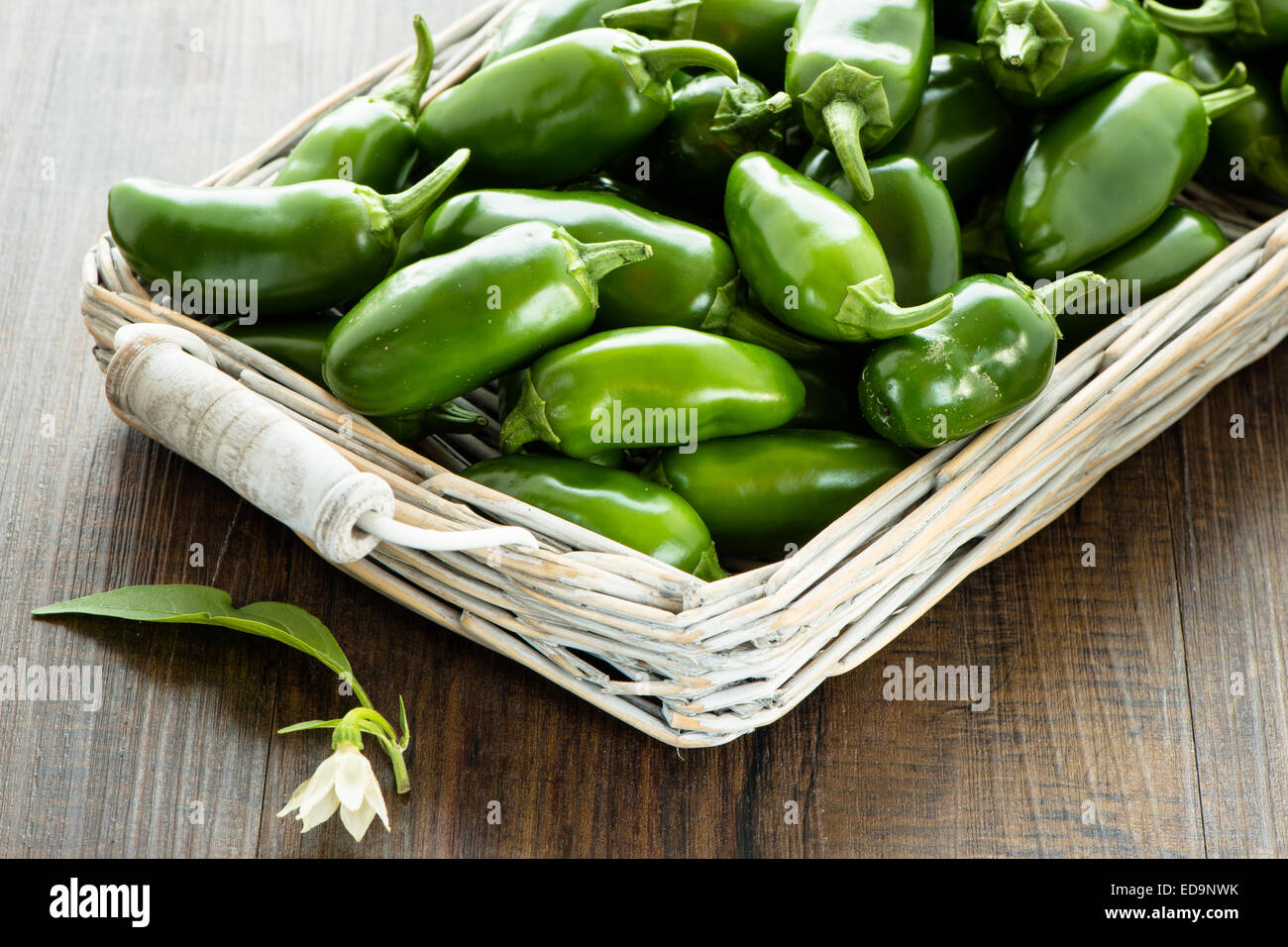 Jalapeno chili pepper with leaf and flower in a basket Stock Photo - Alamy