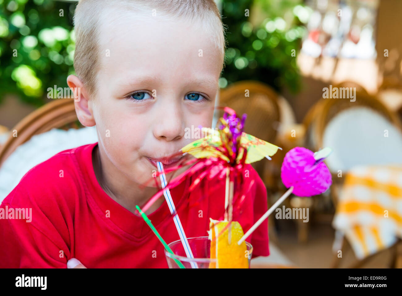 5 years old boy drinking a delicious fruit cocktail Stock Photo