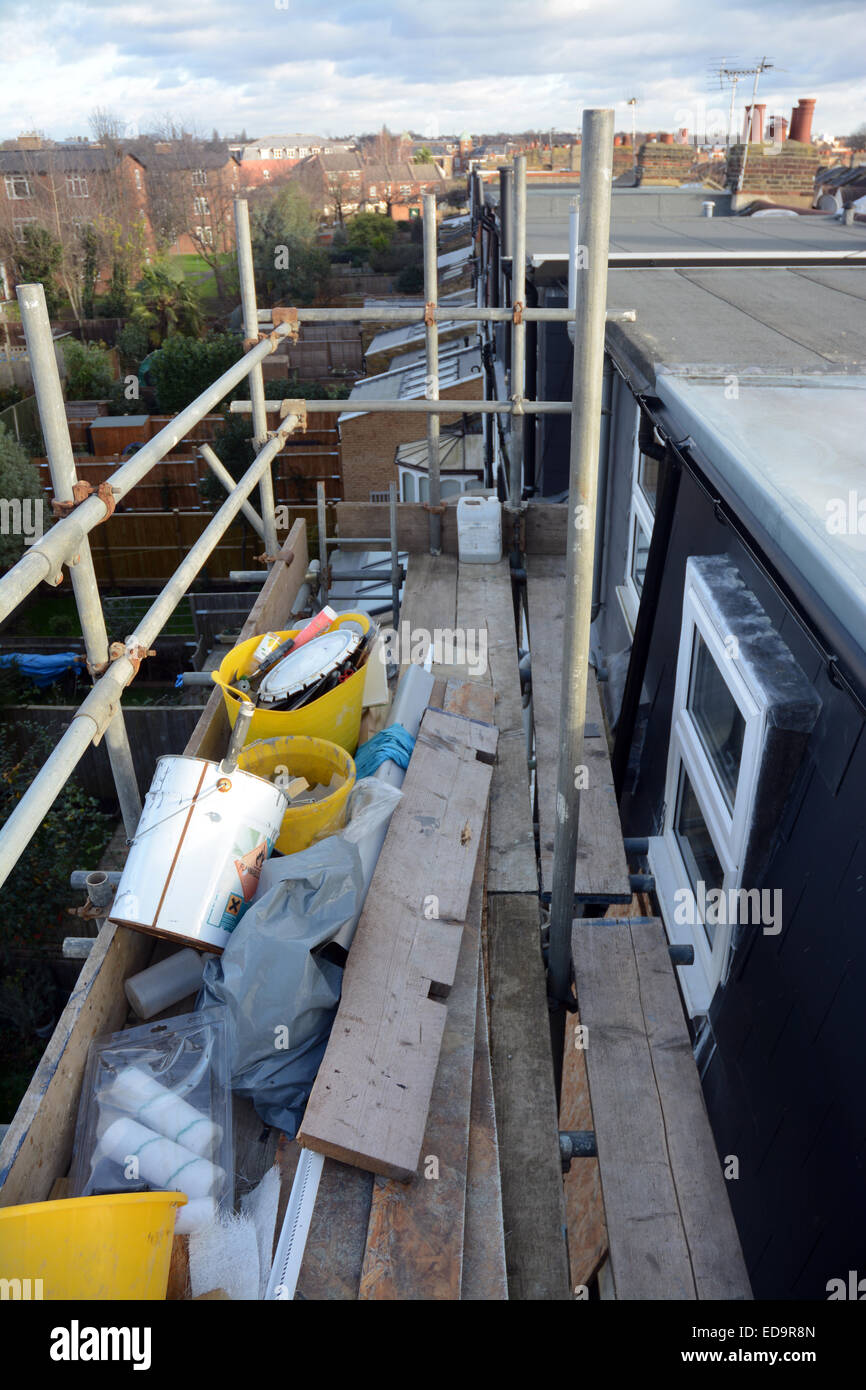 Outside view of a nearly completed loft conversion in southwest London showing scaffolding and builder's tools Stock Photo