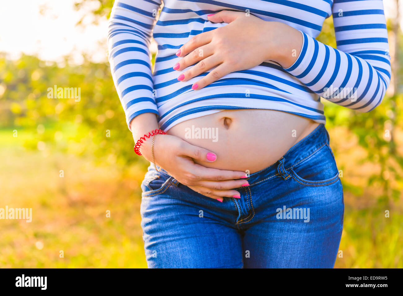 growing belly expectant mother closeup shot Stock Photo