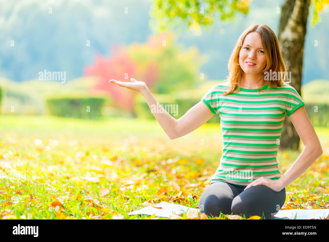 portrait of a young woman holding her hand and smiling Stock Photo - Alamy