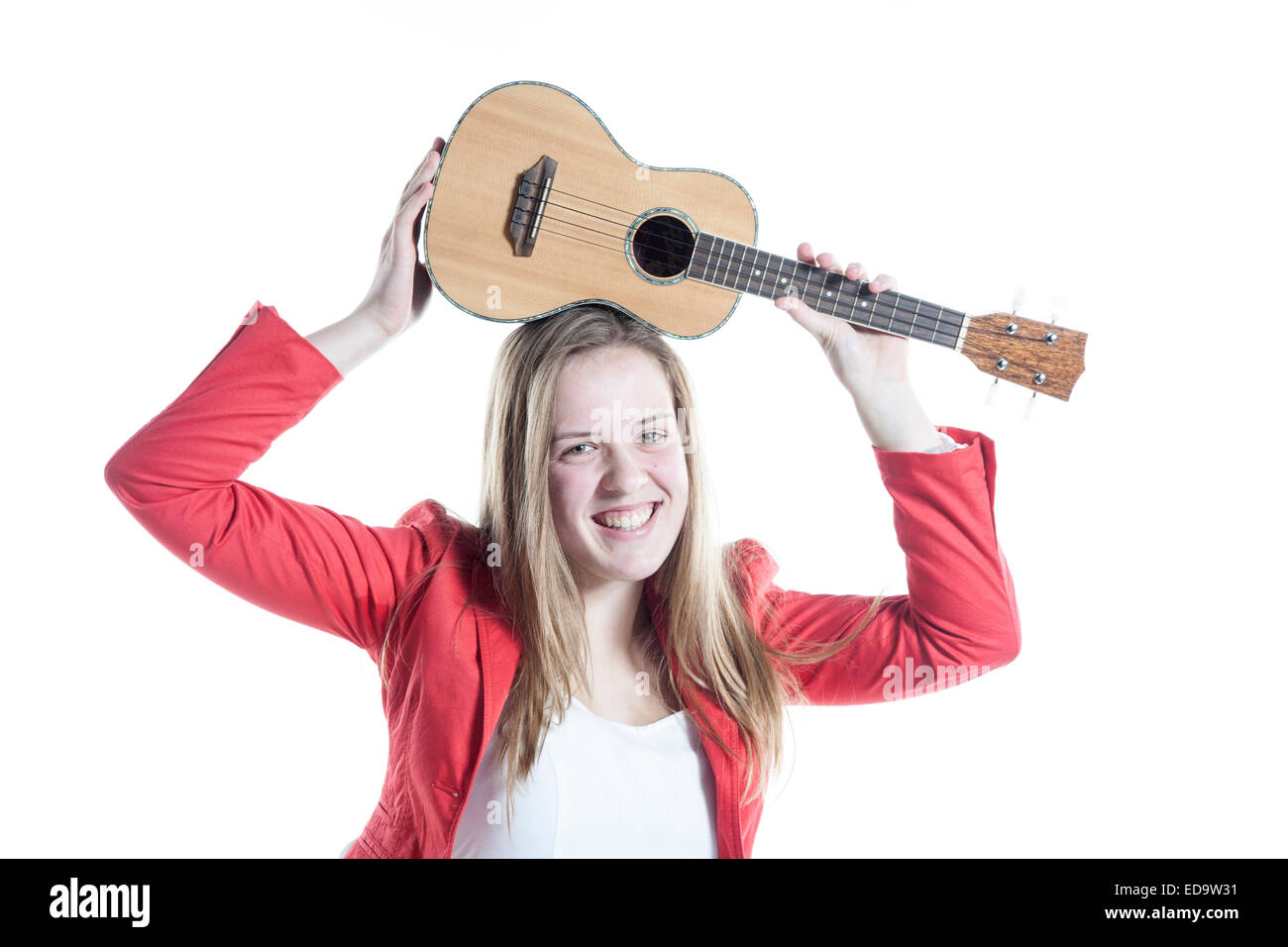teenage girl holds ukulele in studio against white background Stock Photo Alamy