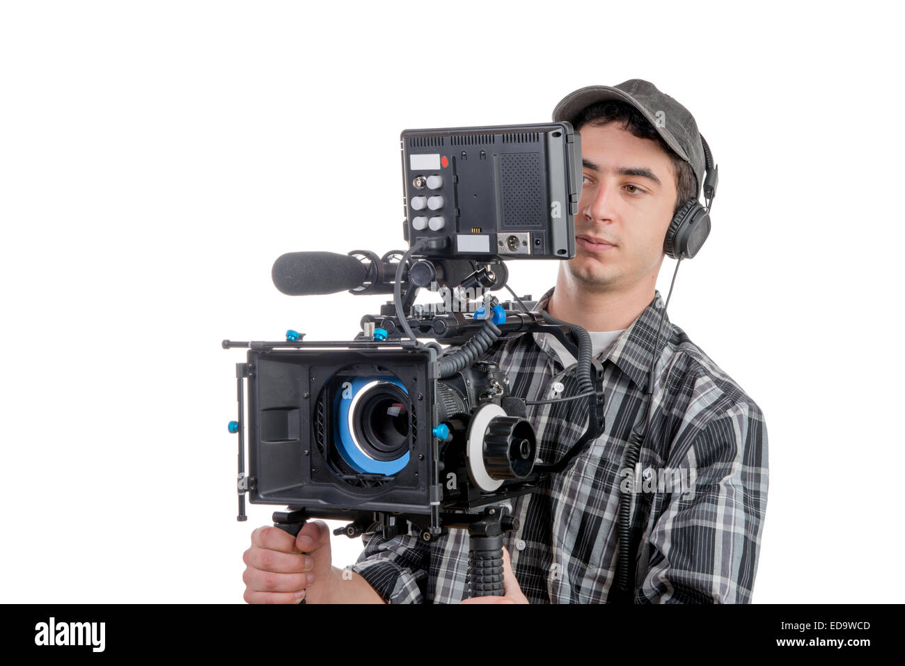 young cameraman with movie camera on the white background Stock Photo