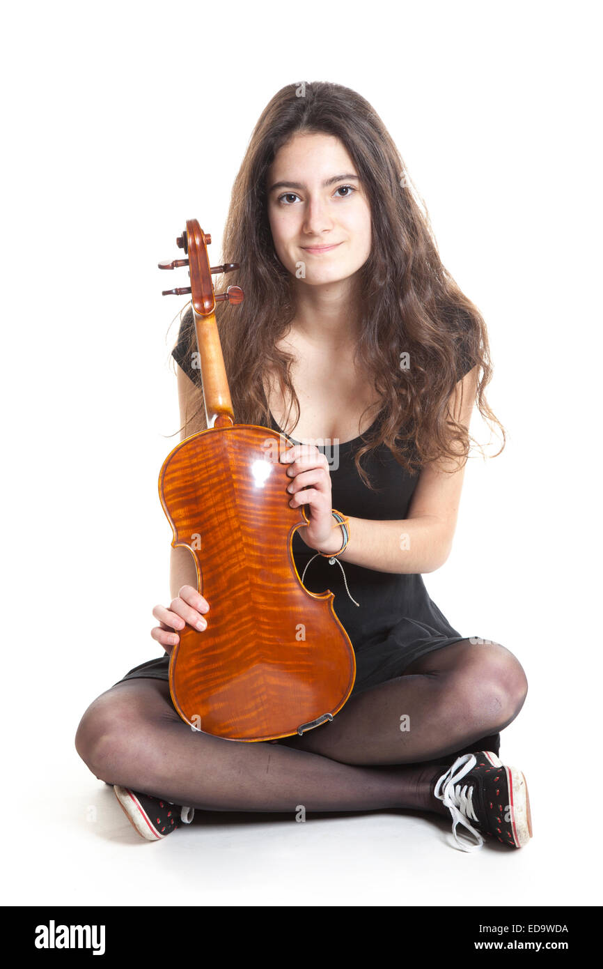 teenage girl holds violin in studio with white background Stock Photo ...