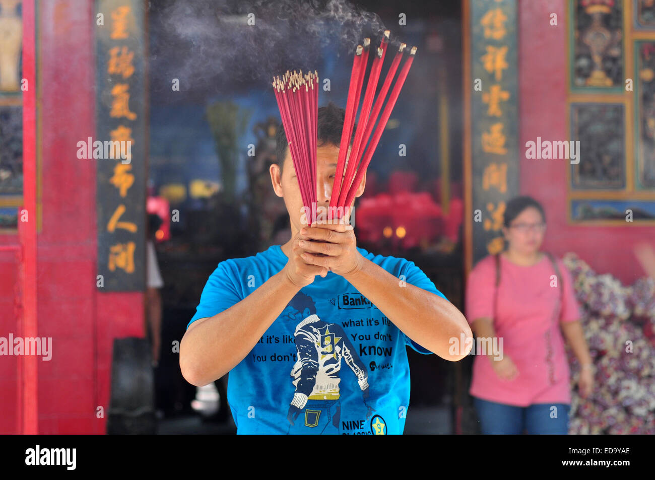 PrayBuddhist praying with incense Stock Photo Alamy